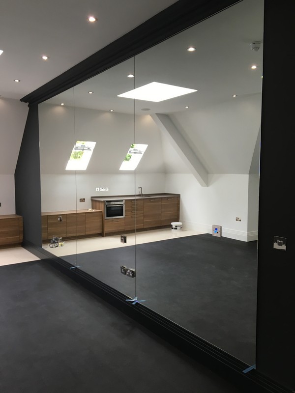 Frameless glass partition in loft conversion by Maida Vale glaziers