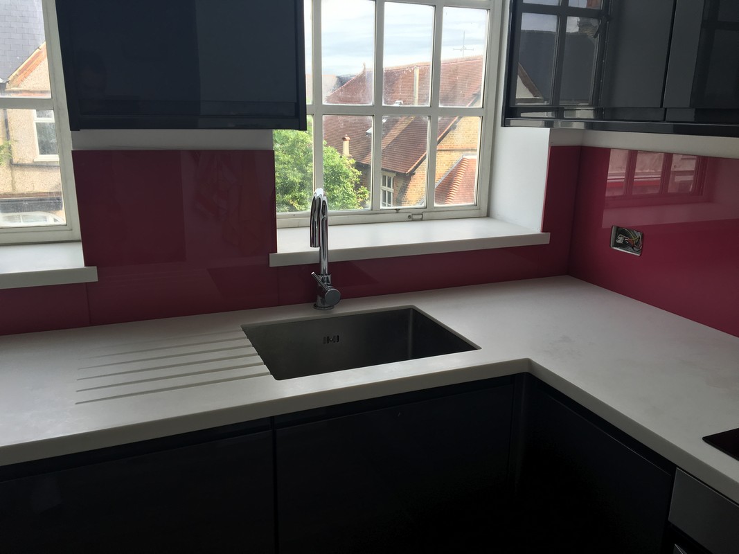 Deep plum coloured glass splashback in modern Maida Vale kitchen